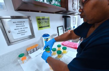 A medical assistant closes bottles of patients' urine submitted for STD testing in Hollywood, California, on May 18th, 2018.