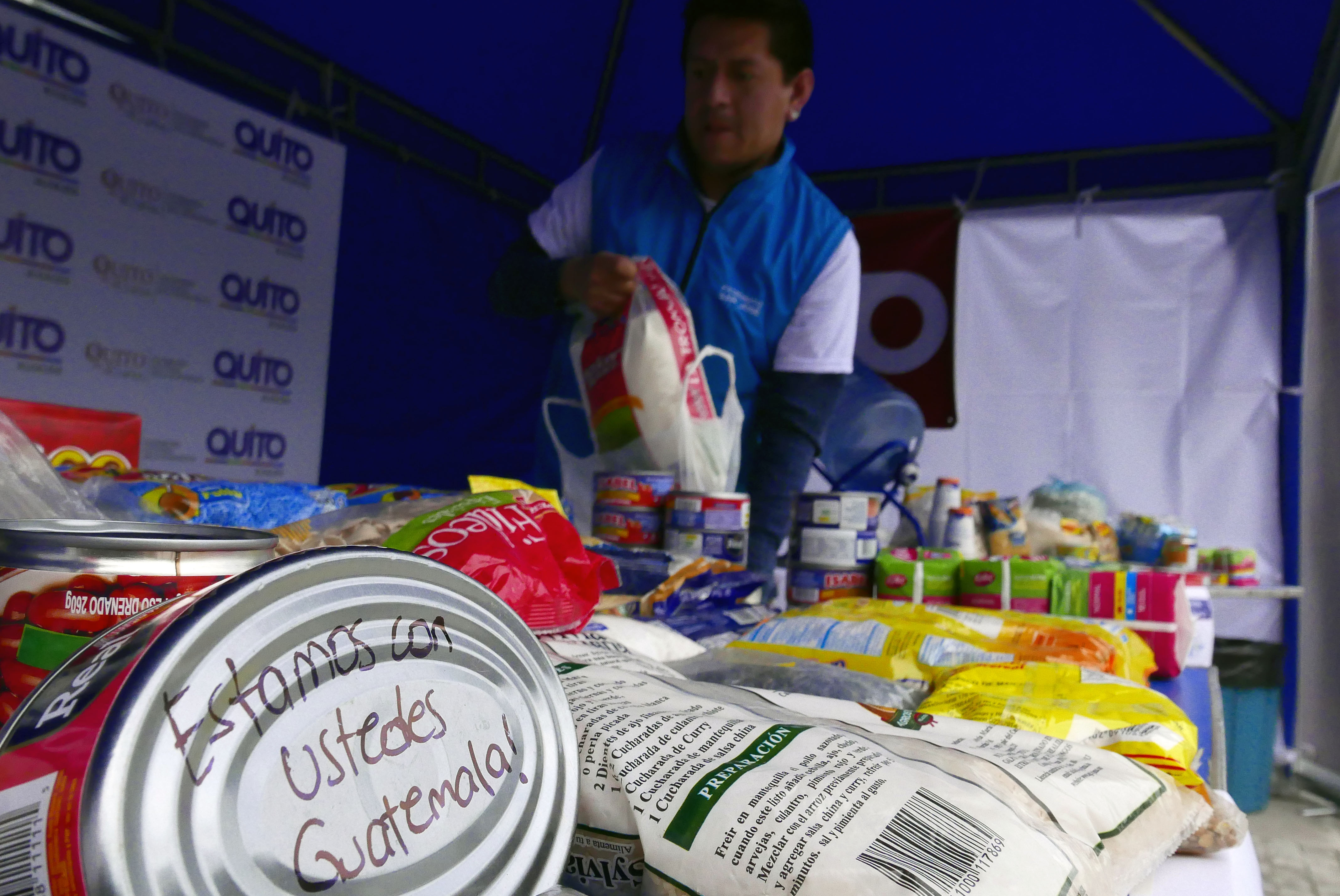 Food cans and packages with solidarity messages are pictured at a collection center of humanitarian aid for the victims of the Fuego volcano in Guatemala, in Quito, on June 5th, 2018.