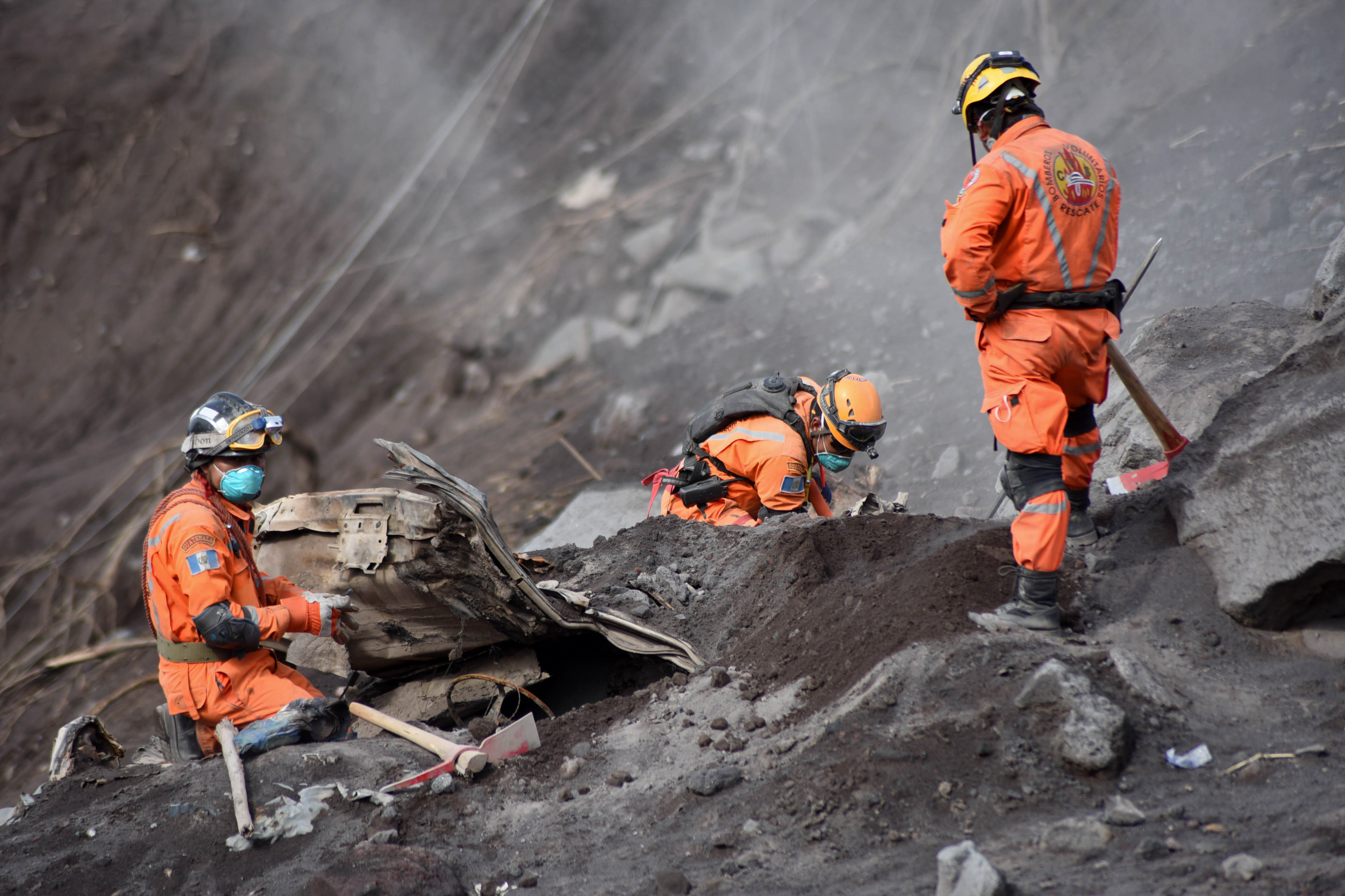 Volunteer firefighters search for victims of the Fuego volcano eruption in Alotenango, a municipality in Sacatepequez, southwest of Guatemala City, on June 6th, 2018.