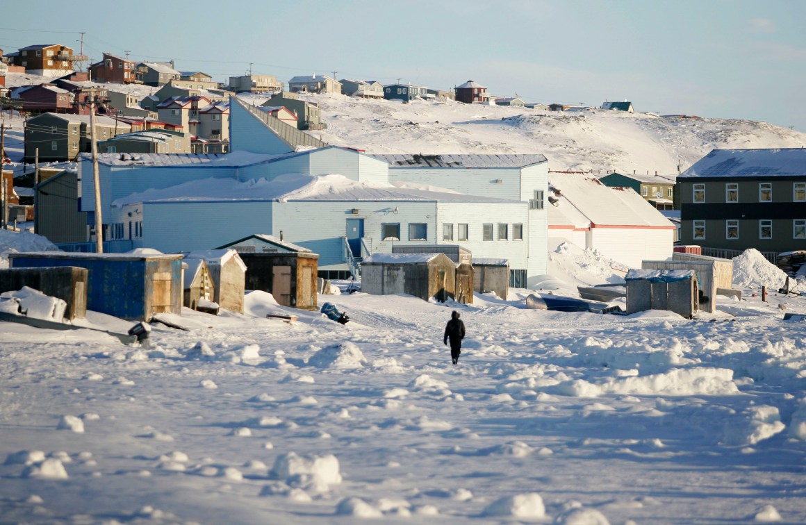 A man walks along the shoreline in Iqaluit, Canada, in February of 2010.