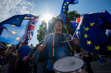 A man bangs a drum as anti-Brexit demonstrators gather outside the Houses of Parliament on June 11th, 2018, in London, England. The European Union withdrawal bill returned to the House of Commons for the first of two sessions in which members of parliament will consider amendments imposed by the Lords, and another set of fresh amendments.