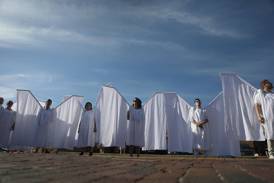 People dressed as angels stand in front of the memorial set up for the shooting victims at Pulse nightclub on June 12th, 2018, where the shootings took place two years ago in Orlando, Florida.