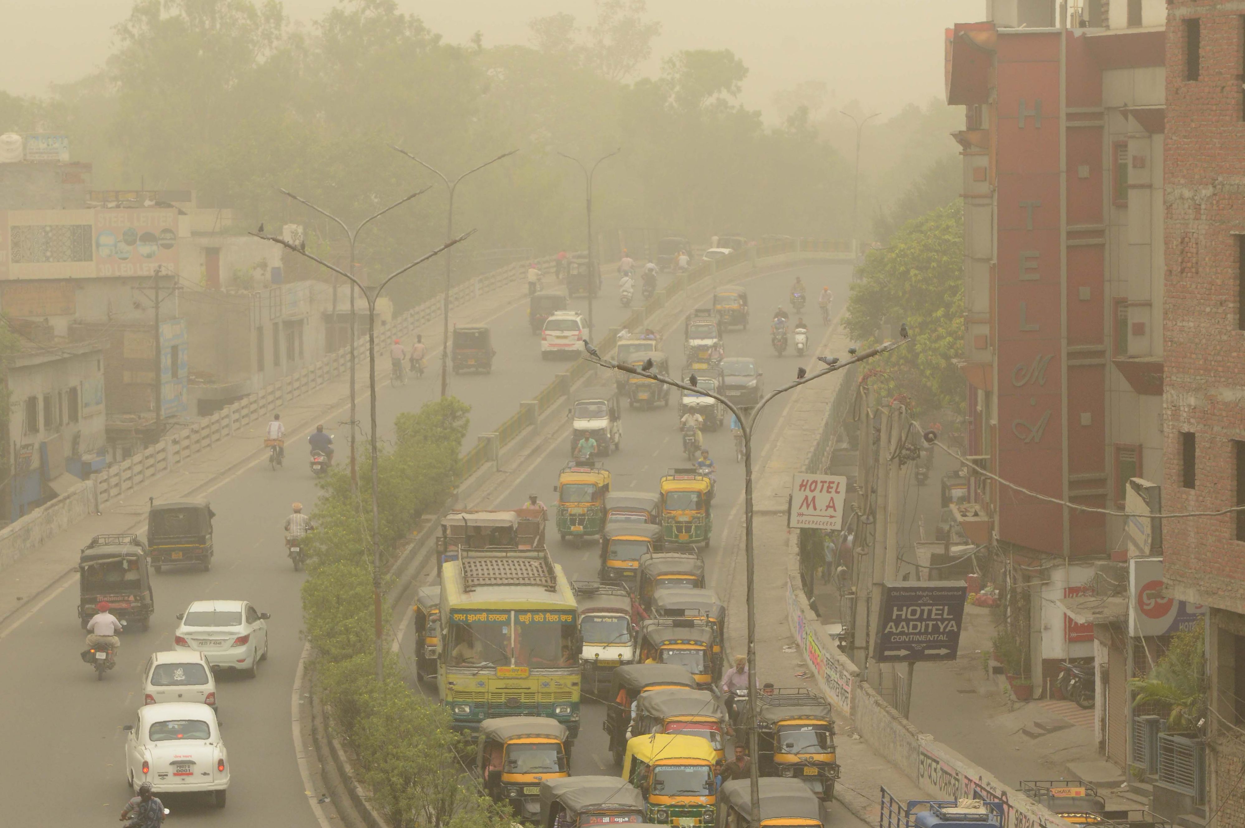 Commuters makes their way as dust covers the sky in Amritsar on June 15th, 2018. Air pollution soared in New Delhi on June 14th to hazardous levels rarely seen outside winter months as sand blown from deserts enveloped the Indian capital in a once-in-a-decade phenomenon. Doctors warned the visible grit carried by hot summer winds posed serious health risks to the city of 20 million and there was little to do 