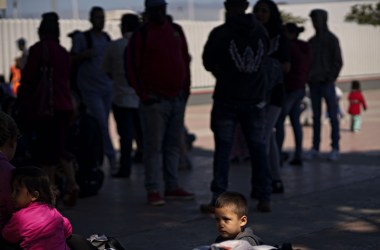 A child waits in line with his parents for an asylum hearing outside of the port of entry in Tijuana, Mexico, on June 18th, 2018.