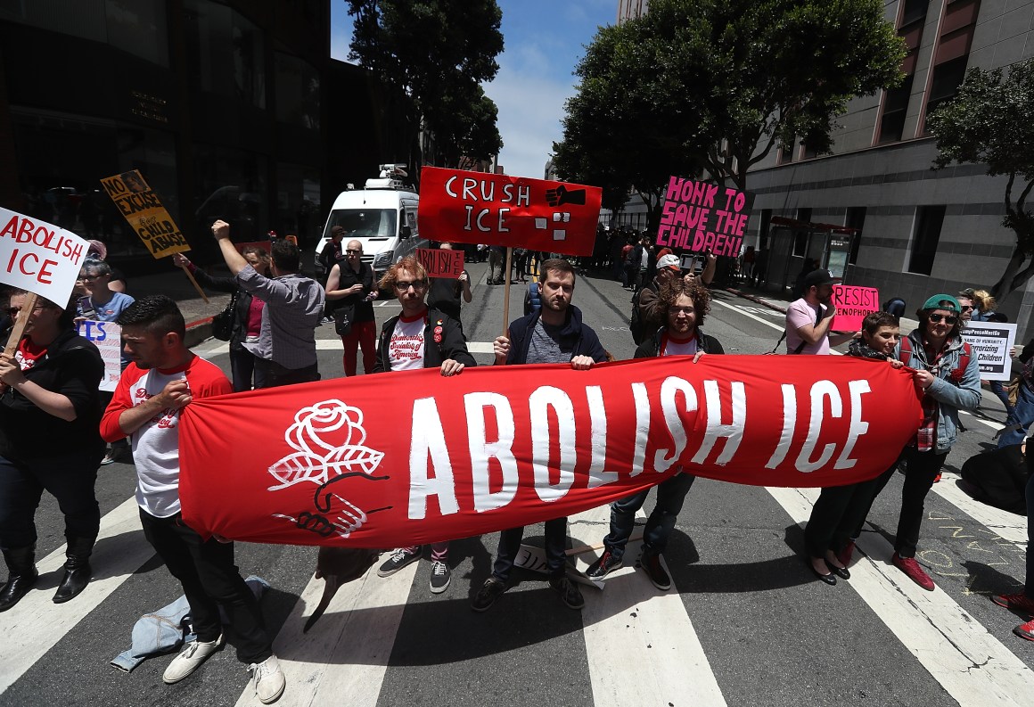 Protesters hold signs as they block Sansome Street during a demonstration outside of the San Francisco office of Immigration and Customs Enforcement on June 19th, 2018, in San Francisco, California. Hundreds of protesters staged a demonstration outside of the ICE offices against the Trump administration's zero tolerance policy to separate immigrant families at the border.