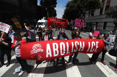 Protesters hold signs as they block Sansome Street during a demonstration outside of the San Francisco office of Immigration and Customs Enforcement on June 19th, 2018, in San Francisco, California. Hundreds of protesters staged a demonstration outside of the ICE offices against the Trump administration's zero tolerance policy to separate immigrant families at the border.