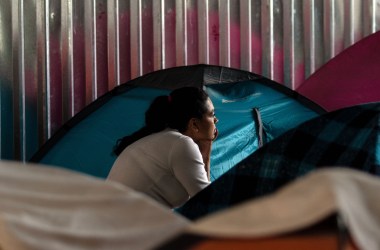 A migrant woman rests at her tent at Juventud 2000 migrant shelter in Tijuana on June 20th, 2018.