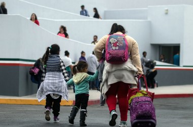 Migrants walk toward the El Chaparral port of entry in Tijuana, Mexico, on June 21st, 2018.