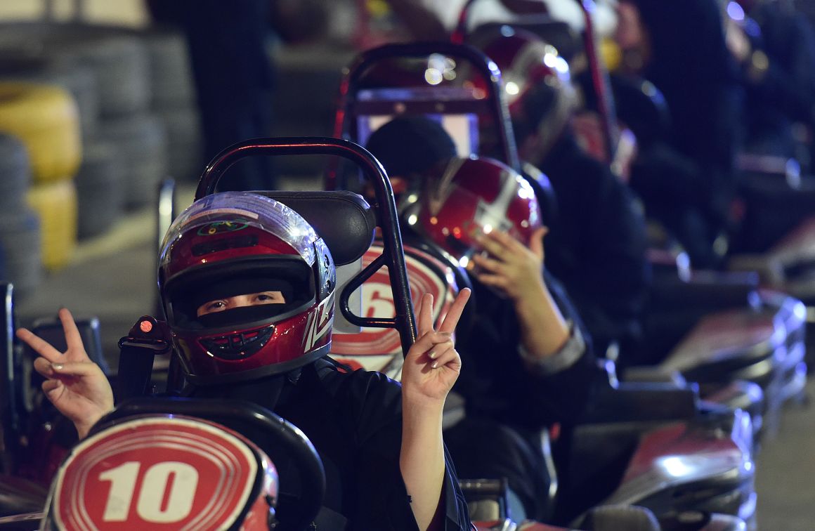 A Saudi woman poses for the camera as she uses a go-cart during a driving workshop for women in the Saudi capital of Riyadh on June 21st, 2018. Saudi Arabia will allow women to drive from June 24th, ending the world's only ban on female motorists, a historic reform marred by what rights groups call an expanding crackdown on activists.