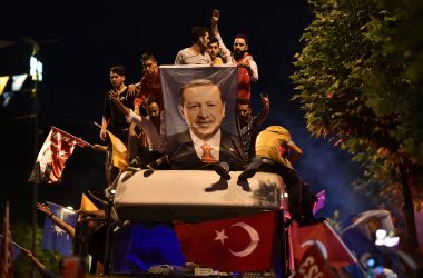 People react and wave flags outside the Justice and Development Party (AKP) headquarters in Istanbul, on June 24th, 2018, during the Turkish presidential and parliamentary elections. More than 59 million citizens voted in the presidential and parliamentary elections. According to state media reports, Turkey's President Recep Tayyip Erdogan has won presidential poll with 53 percent of the vote after nearly all votes have been counted.