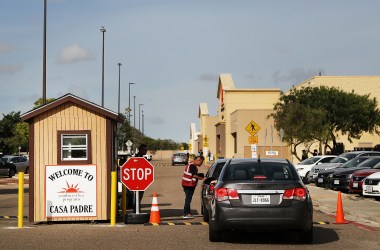 A security guard checks cars at the entrance to Casa Padre, a former Walmart that is now a center for unaccompanied immigrant children, on June 24th, 2018, in Brownsville, Texas.