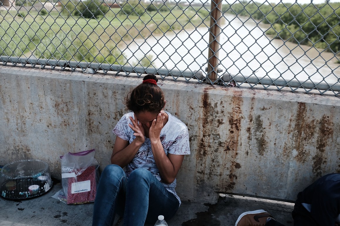 A Honduran woman waits along the border bridge after being denied entry into the U.S. from Mexico on June 25th, 2018, in Brownsville, Texas.