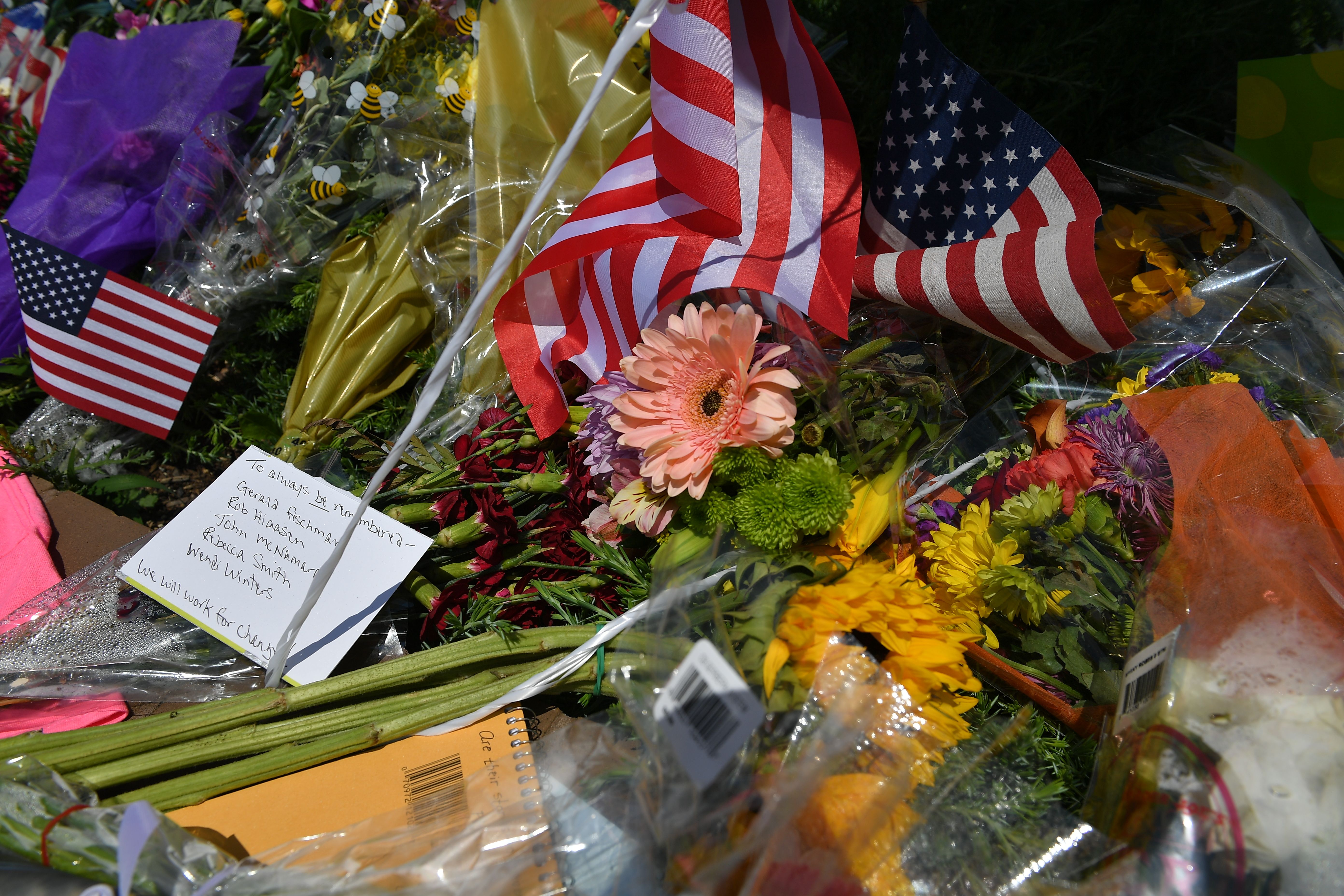 Flowers, United States flags, and messages adorn a makeshift memorial for five people killed at the Capital Gazette newspaper on June 28th, in Annapolis, Maryland. Jarrod Ramos, who carried out a deadly assault on the newspaper office, had barricaded a back door in an effort to 