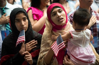 New United States citizen Mosammat Rasheda Akter, originally Bangladesh, holds her seven-month-old daughter Fahmida as she sings the U.S. National Anthem during naturalization ceremony at the New York Public Library on July 3rd, 2018, in New York City. Two hundred immigrants from 50 countries became citizens during the ceremony.