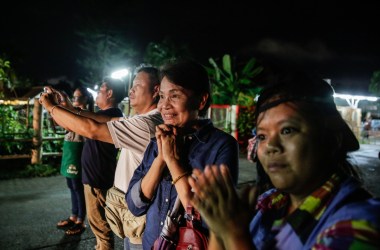 Onlookers cheer as ambulances deliver boys rescued from a cave in northern Thailand to a hospital on July 8th, 2018, in Chiang Rai, Thailand. Divers began an effort to pull the 12 boys and their soccer coach on Sunday morning after they were found alive in the cave in northern Thailand.