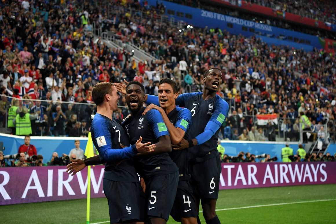 Samuel Umtiti of France celebrates with teammates after scoring his team's first goal during the 2018 FIFA World Cup Russia semi-final match between Belgium and France.