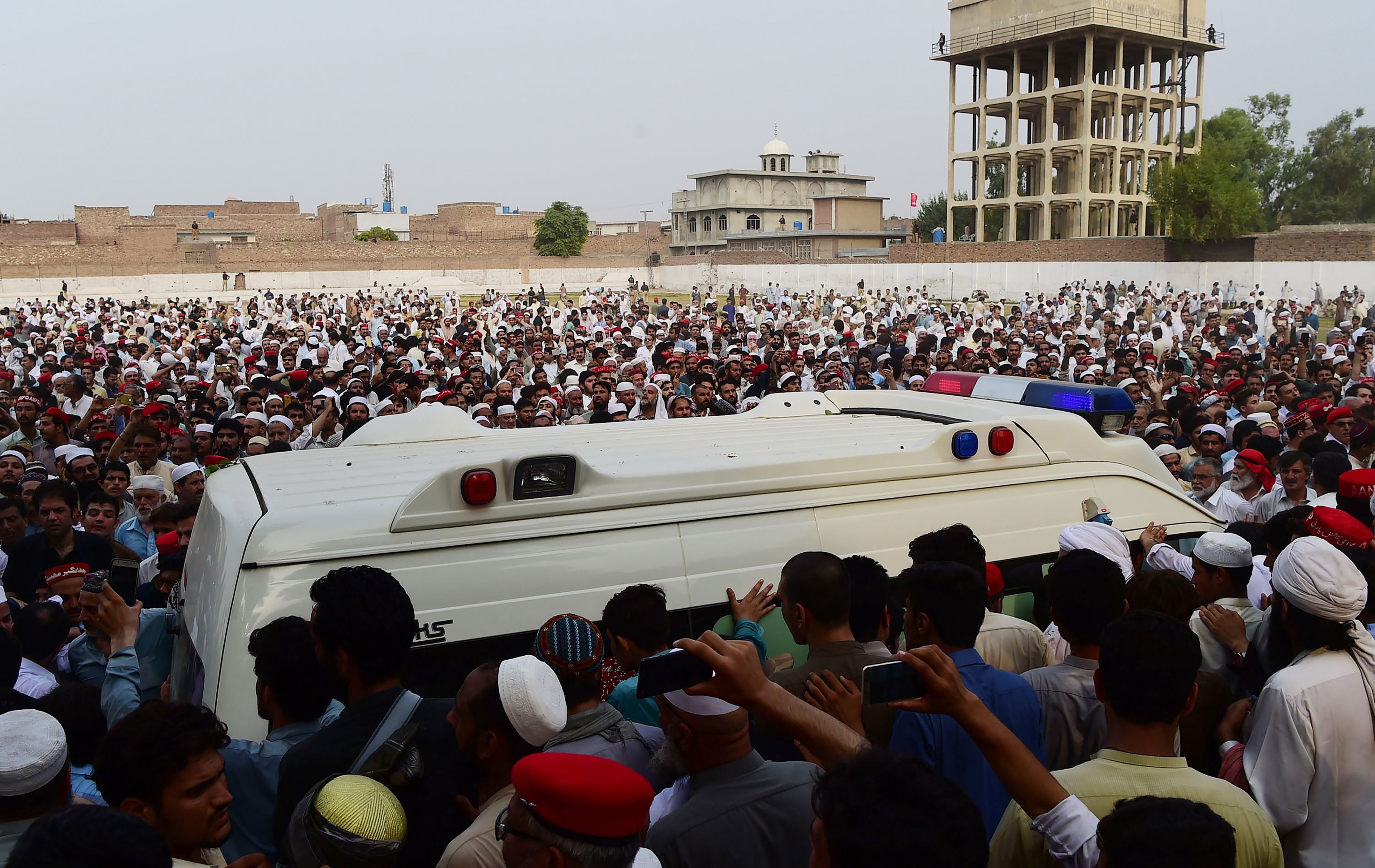 Pakistani supporters of the Awami National Party gather around an ambulance carrying the body of a local leader and ANP candidate, Haroon Bilour, at a funeral in Peshawar on July 11th, 2018.