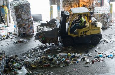 Workers sort recycling material at the Waste Management Material Recovery Facility in Elkridge, Maryland, on June 28th, 2018.