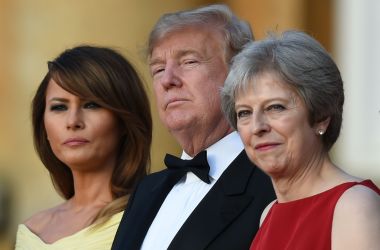 U.S. First Lady Melania Trump, President Donald Trump, and Britain's Prime Minister Theresa May stand on the steps in the Great Court on the first day of Trump's visit to the United Kingdom.