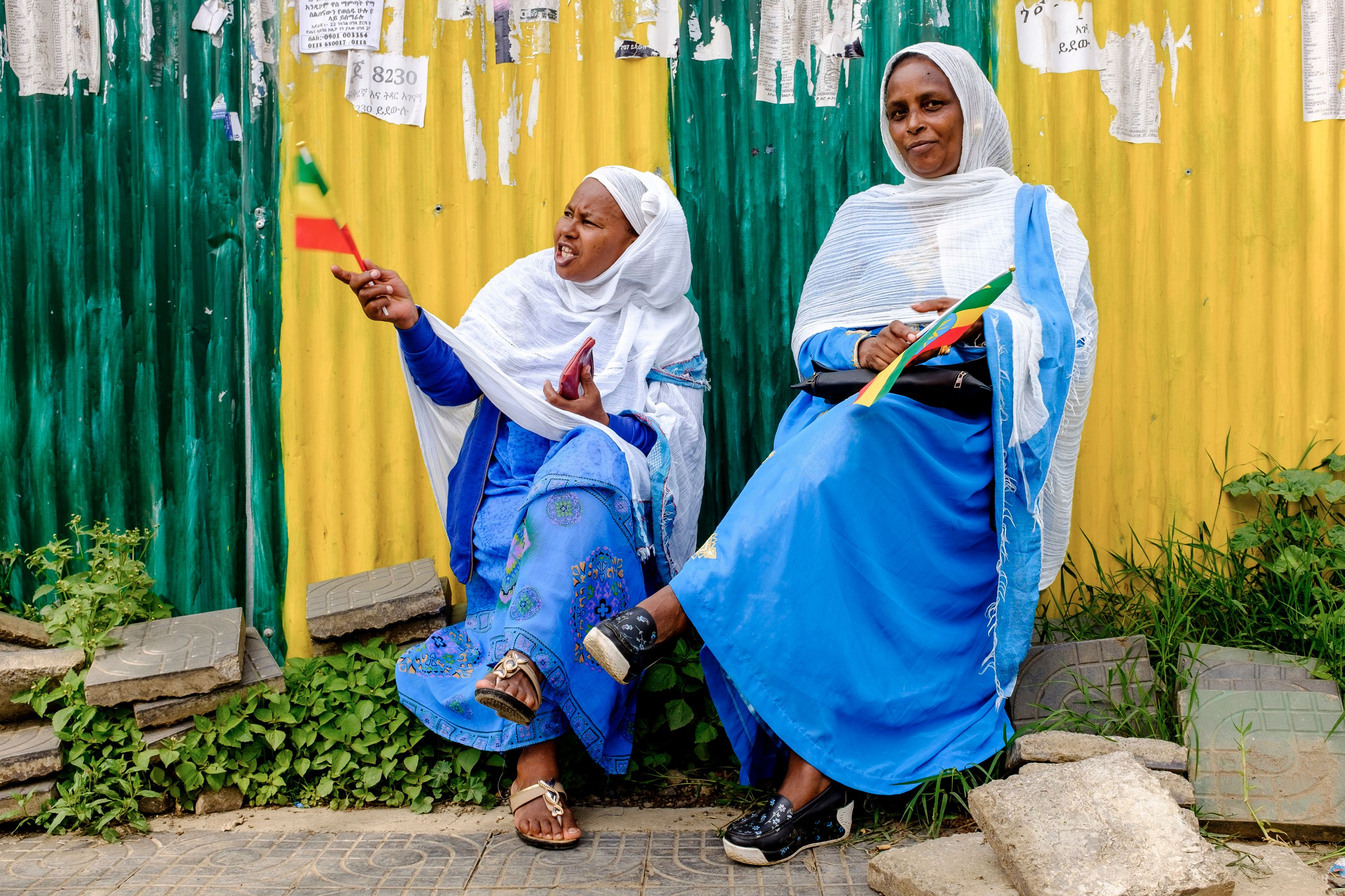 Women wave Ethiopian flags to celebrate the arrival of the Eritrean president in Addis Ababa on July 14th, 2018. President Isaias Afwerki arrived in Ethiopia for a historic visit to cement peace less than a week after the two nations declared an end to a two-decade conflict.