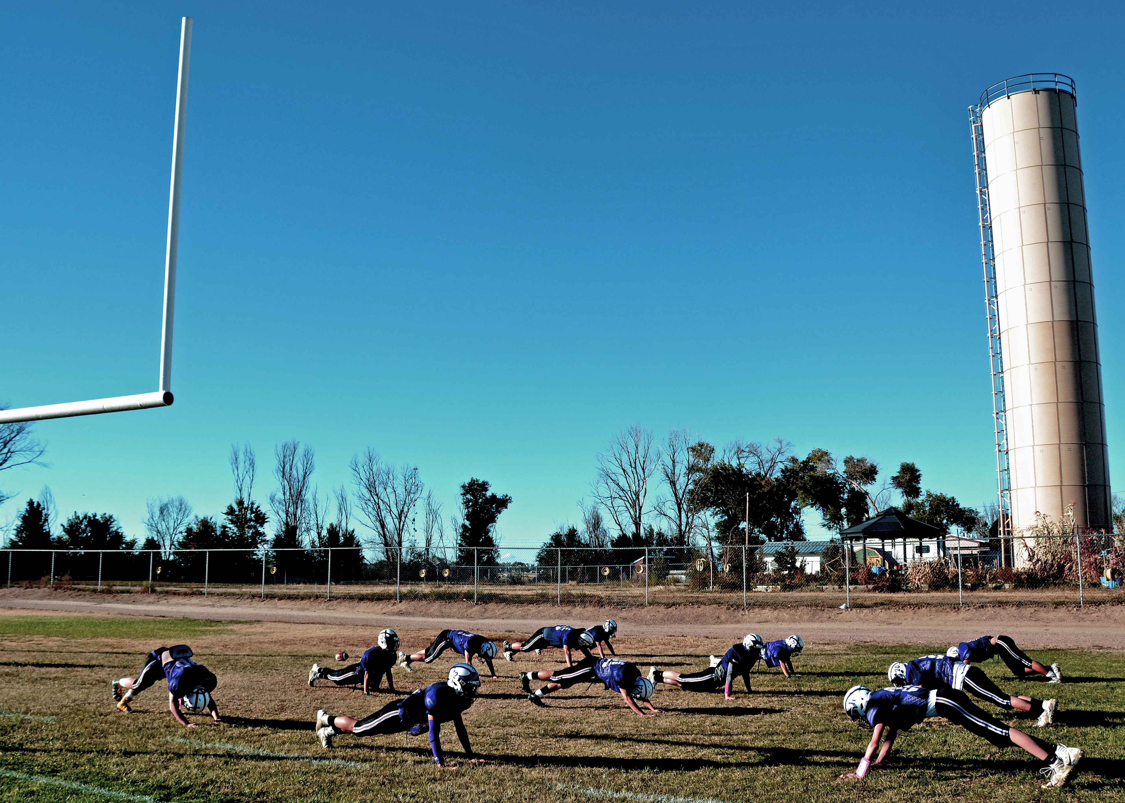 High schoolers practice on the football field in Cheraw, Colorado, a century-old town whose economy is based primarily around agriculture.