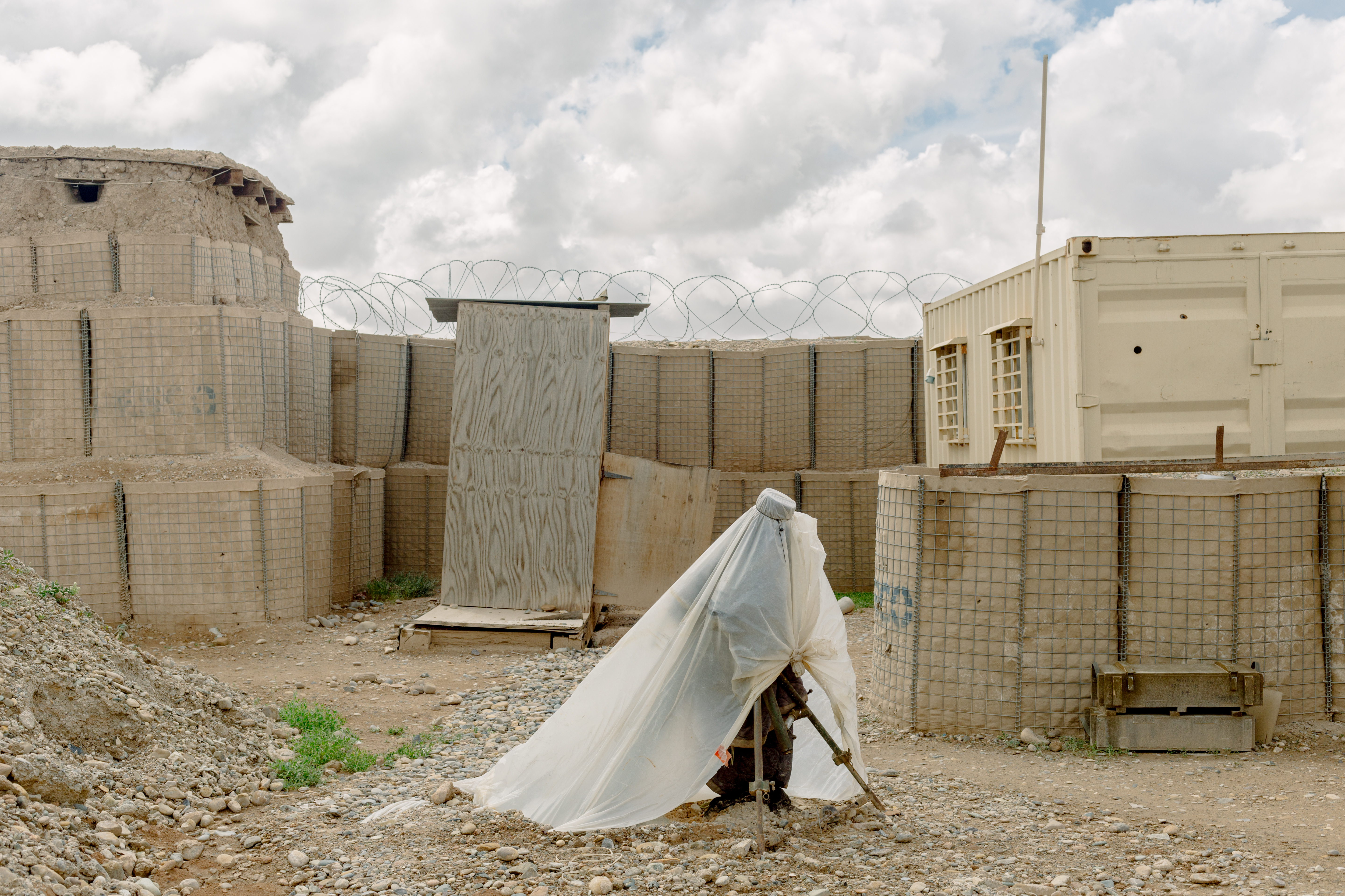 A tarp covers a mortar tube and ammunition at an Afghan National Army base in Helmand Province in April of 2019.