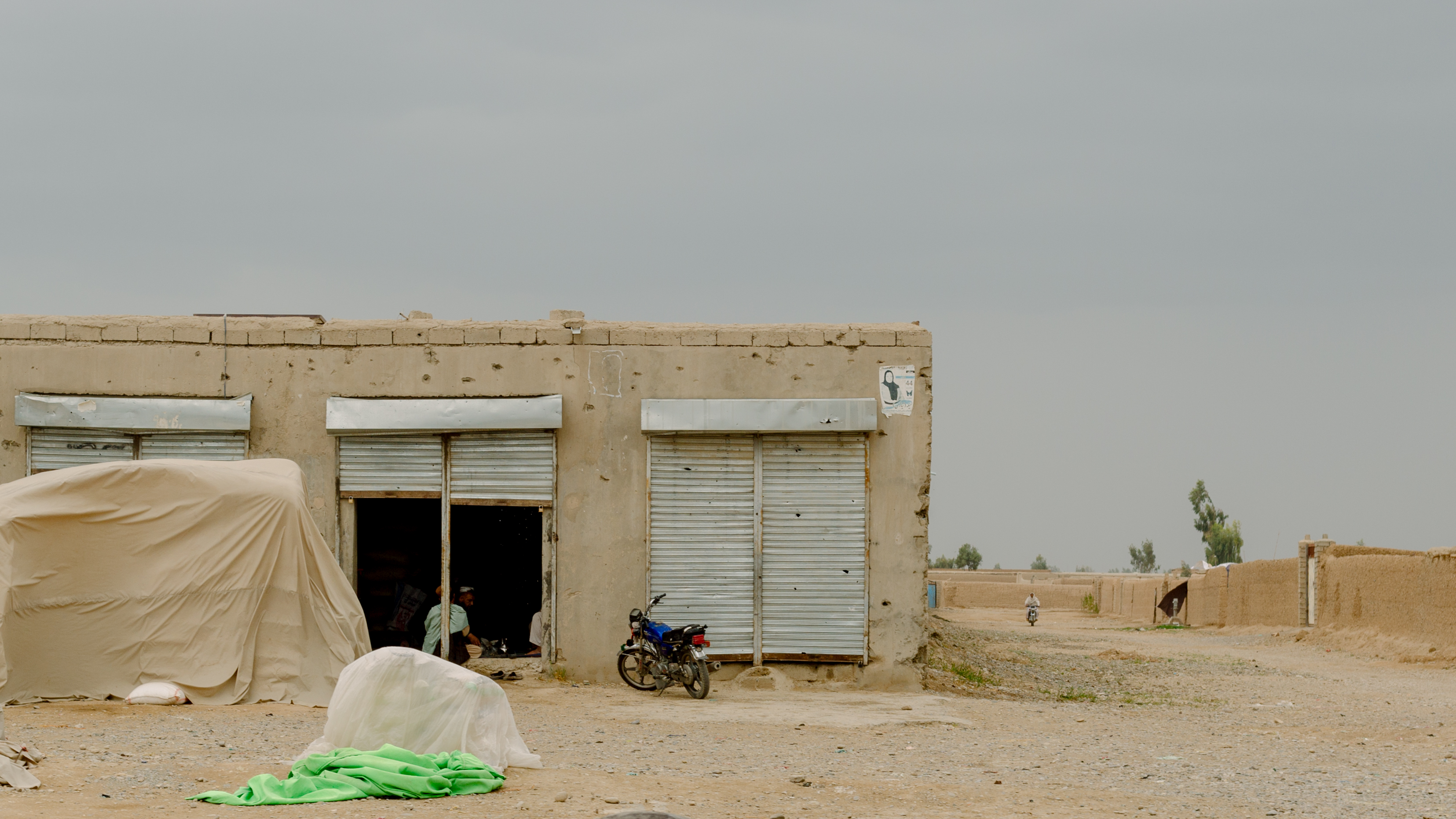 Buildings damaged by fierce fighting are seen in April of 2019 next to the road connecting Nad Ali and Lashkar Gah, the capital of Helmand Province. Most of the bullet holes are a reminder of 2016, when the Taliban pushed government forces back to Lashkar Gah, where they were surrounded until U.S. airstrikes helped the Afghan forces retake some territory.