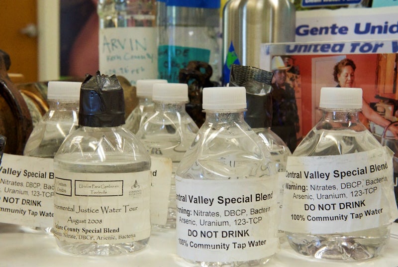 Bottles filled with contaminated tap water from San Joaquin Valley communities are on display at the Visalia, California, office of the Community Water Center, which advocates for clean drinking water for all.