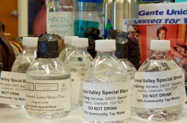 Bottles filled with contaminated tap water from San Joaquin Valley communities are on display at the Visalia, California, office of the Community Water Center, which advocates for clean drinking water for all.