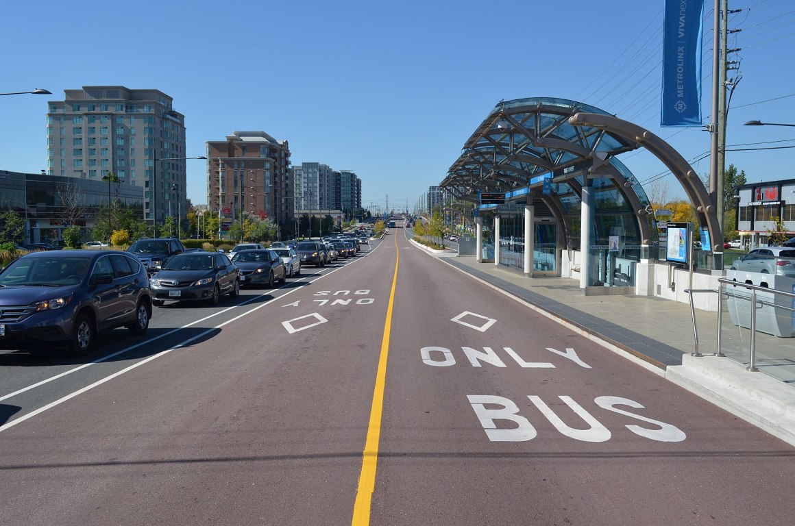 A bus lane next to lines of traffic.