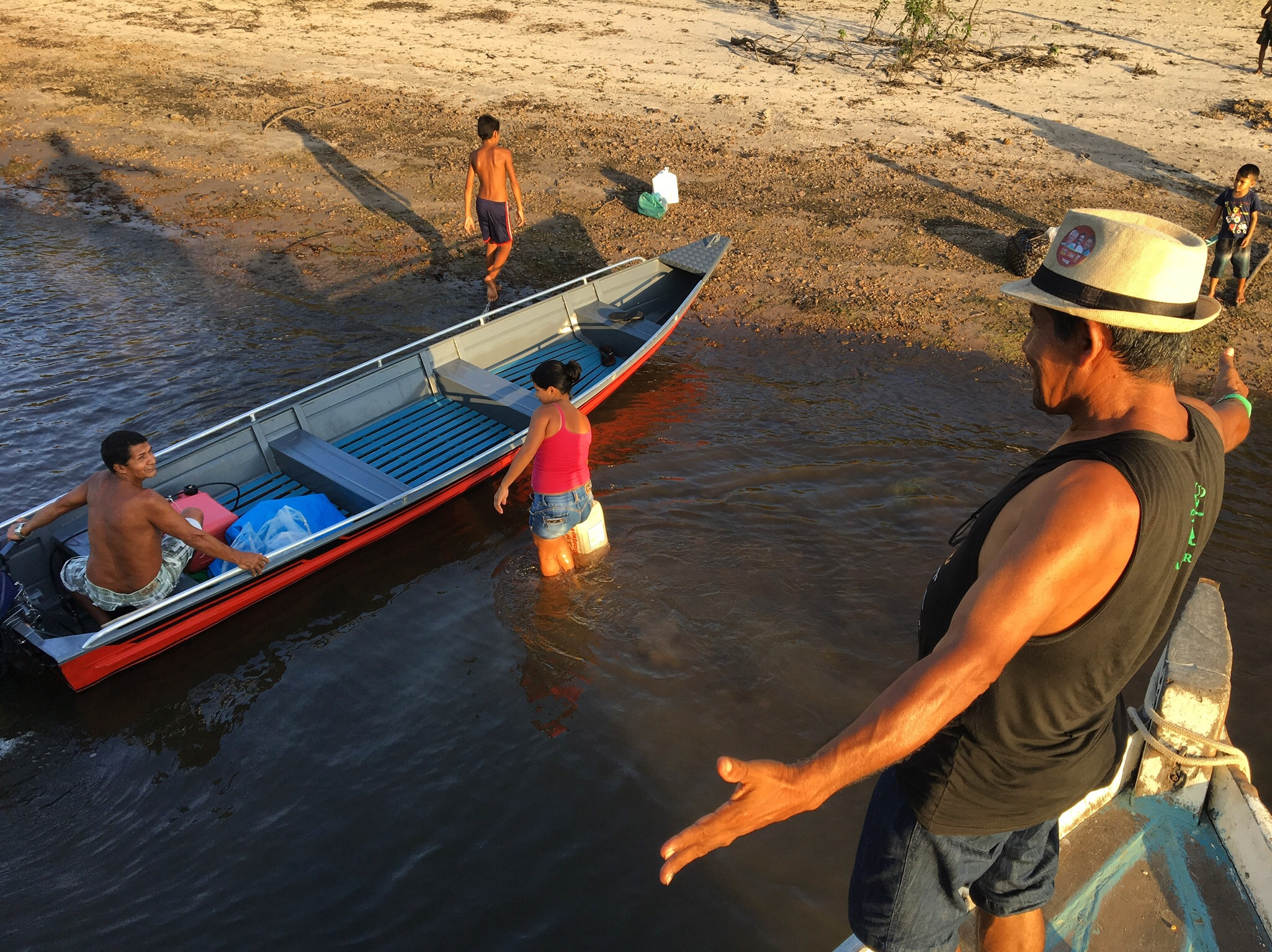 Voting in Brazil's presidential election — Livaldo Sarmento greets villagers from a neighboring community along the Arapiuns River. Many of the ribeirinhos along the river know each other from trips on the boats.