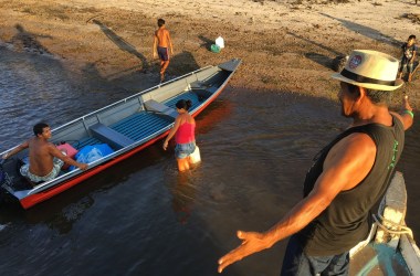 Voting in Brazil's presidential election — Livaldo Sarmento greets villagers from a neighboring community along the Arapiuns River. Many of the ribeirinhos along the river know each other from trips on the boats.