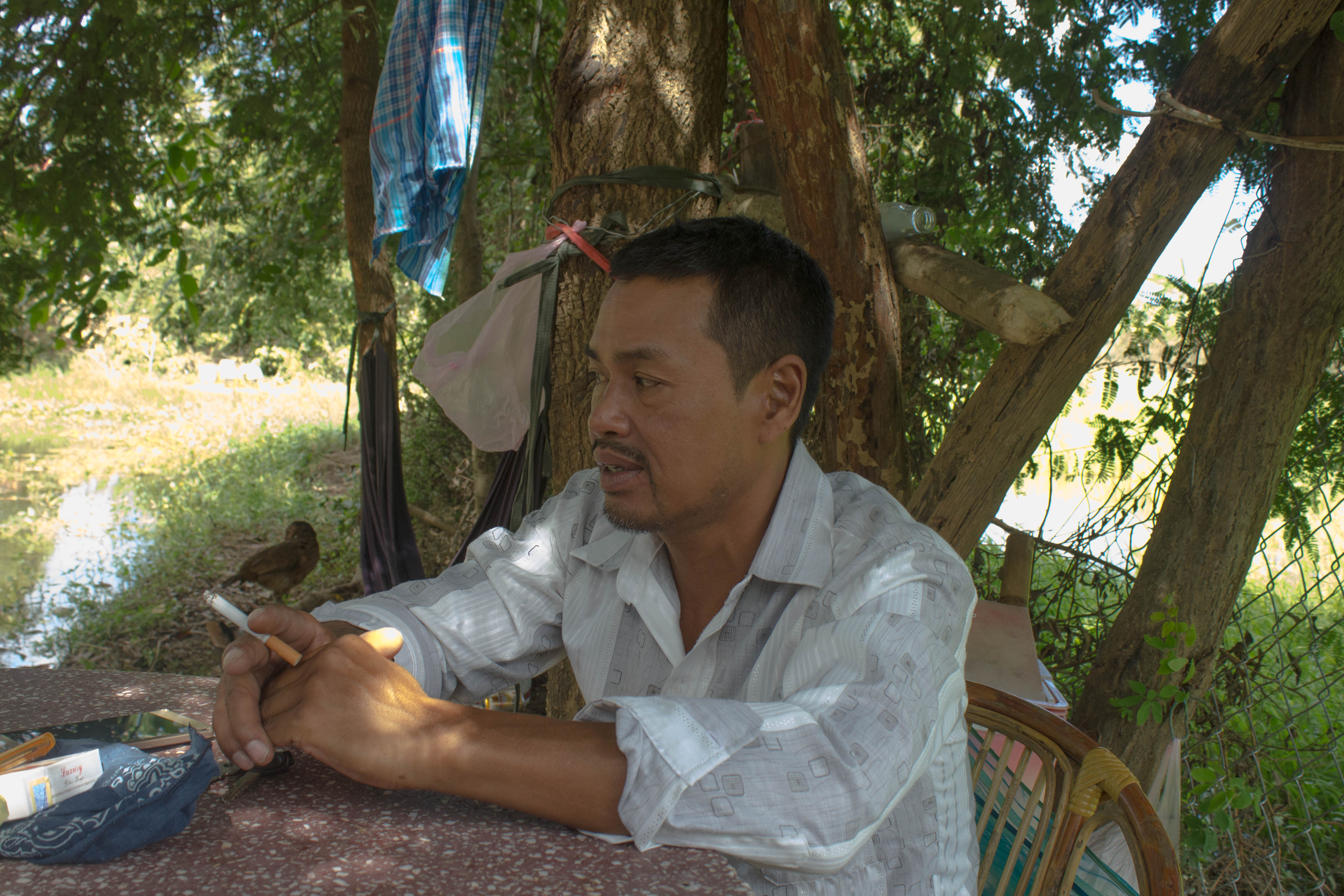 Nheb Thai in his yard.