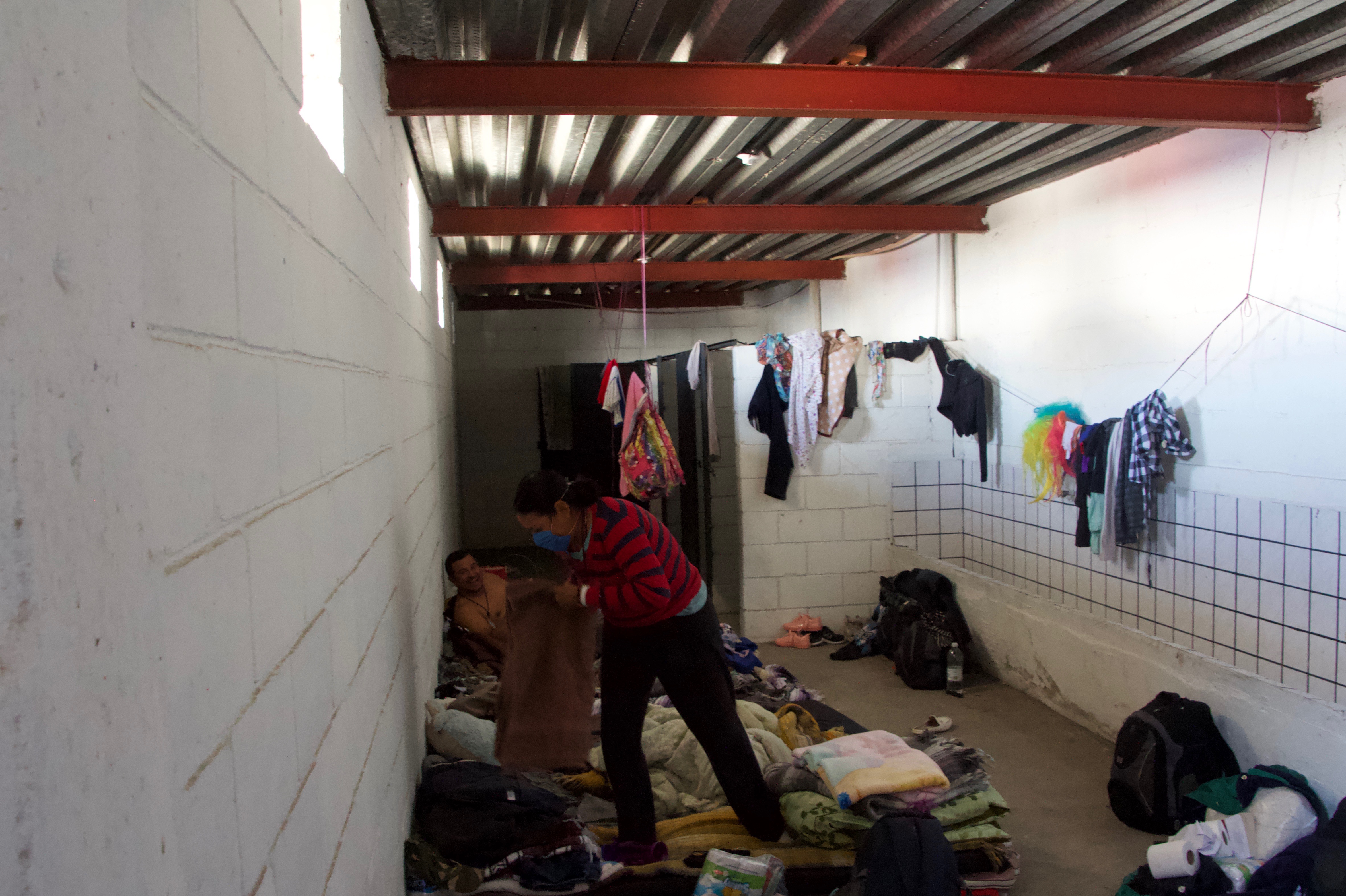 A family of migrants from El Salvador live inside one of the defunct bathrooms in El Barretal.