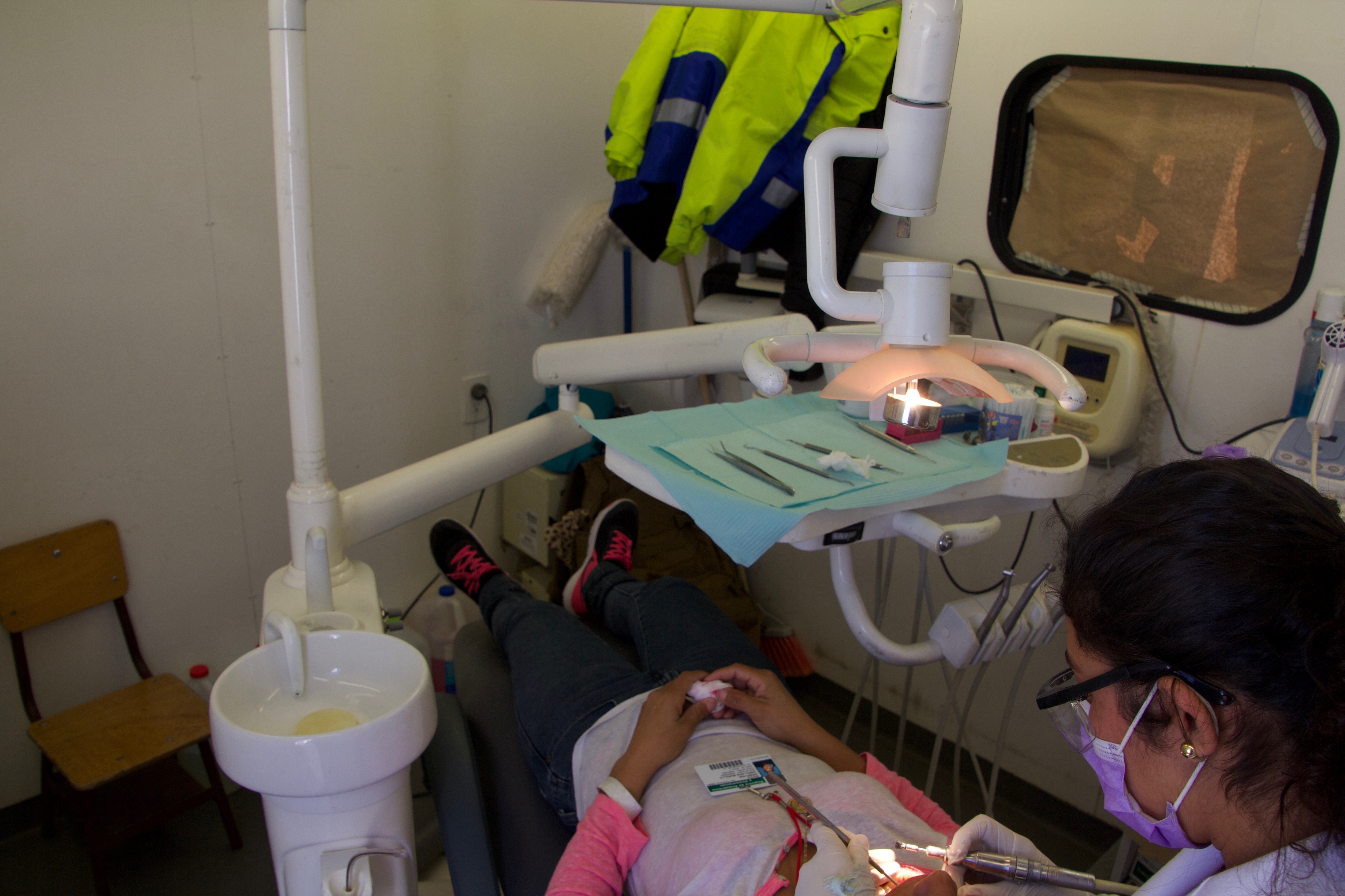 A migrant receives dental work in the mobile dental office operated by the Mexican government.