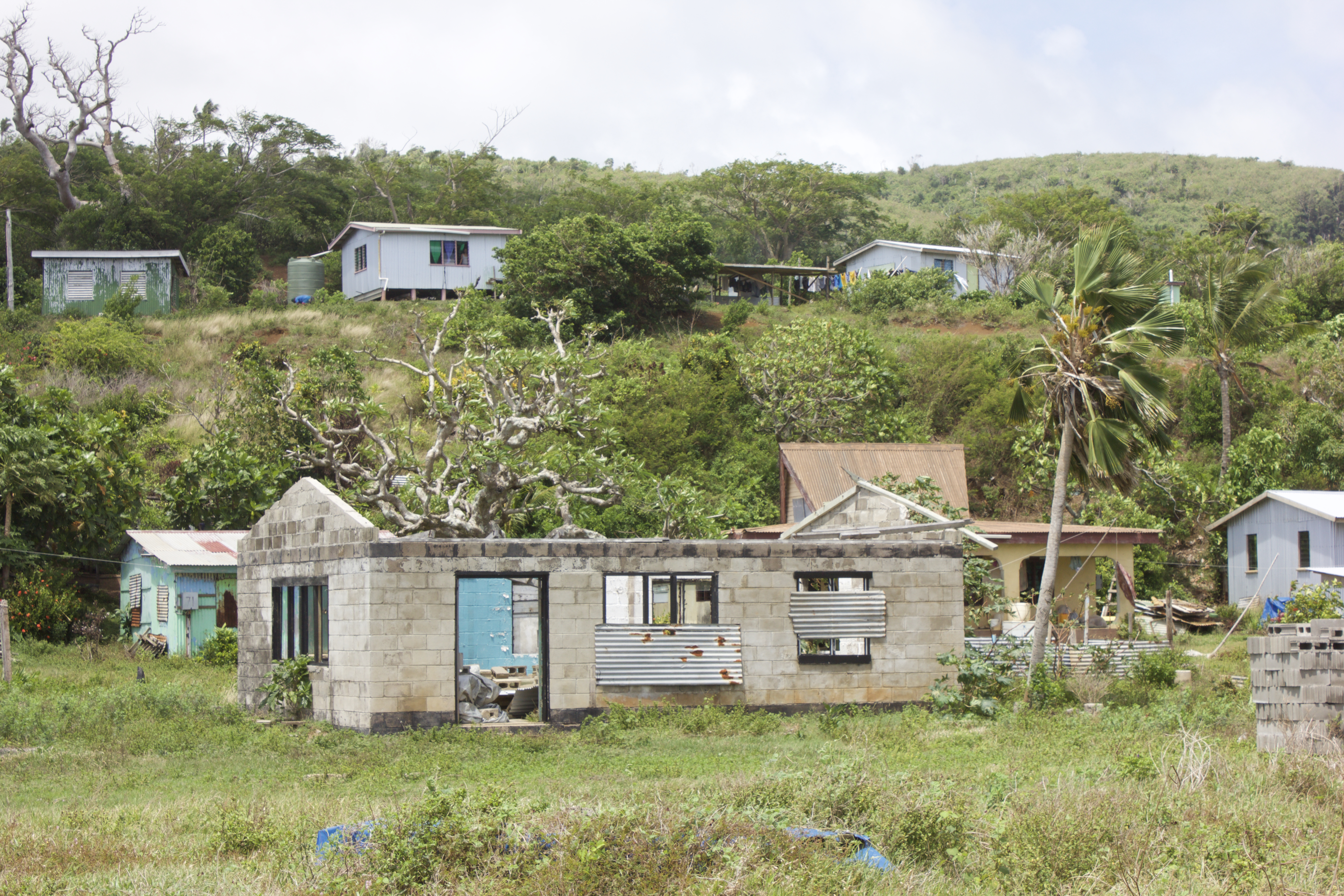 In the village of Nacamaki remains of old houses in the low-lying coastal village sit near new houses on the hills above.