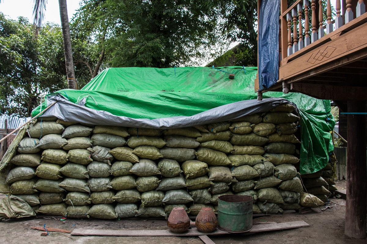 Charcoal bags waiting to be transported near Katha, Myanmar. The charcoal will be sent to Bhamo before going to China.