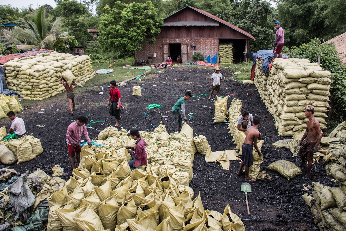 Charcoal bags stored in a lot in Bhamo, Myanmar. Approximately 500 bags are held here, before being loaded onto trucks and sent to China, which is about 50 miles away.