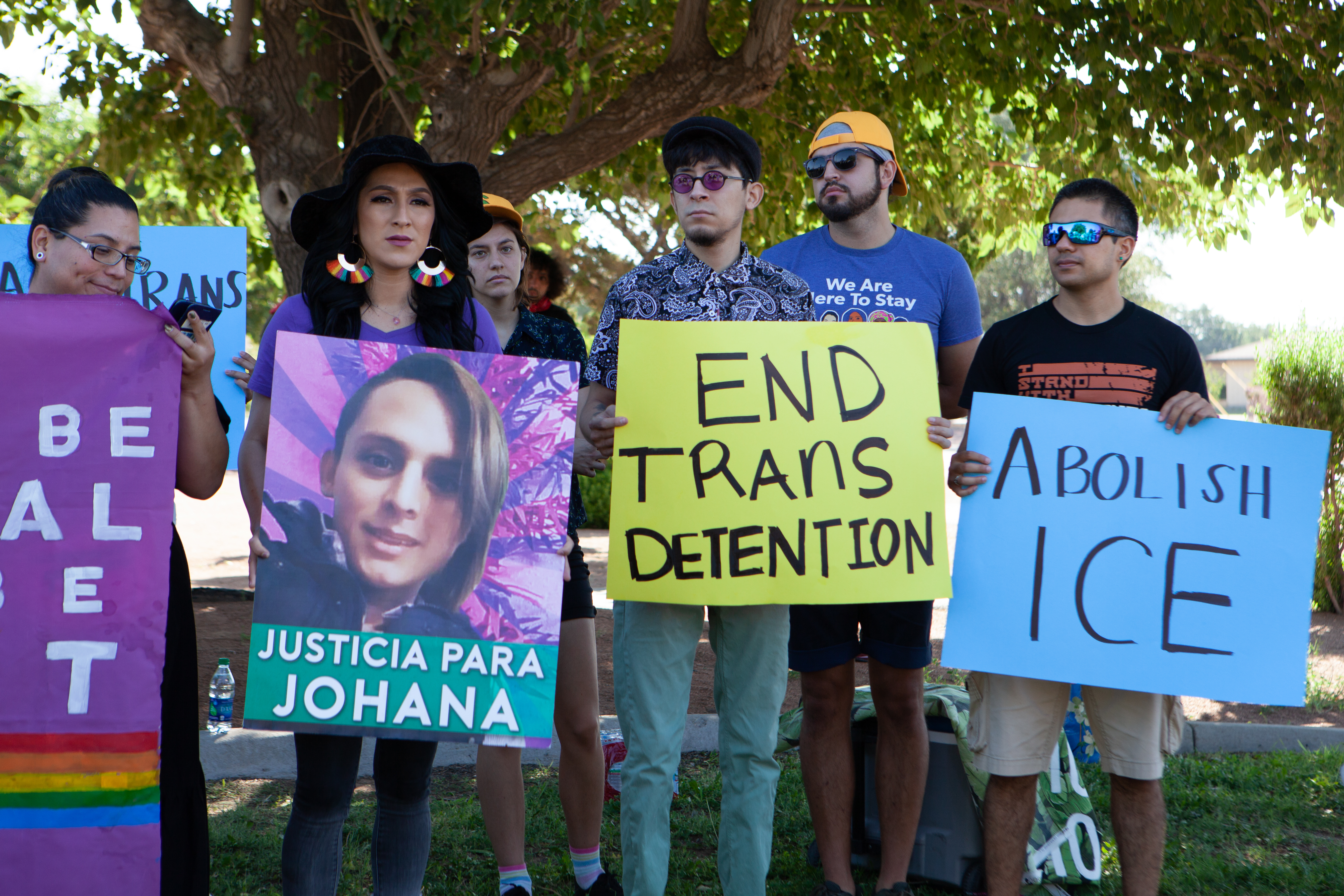 At the march in El Paso on Tuesday, a protester holds a sign bearing the photo of Johana Medina Leon, a trans woman from El Salvador who died in a hospital after falling increasingly ill in an ICE detention center in El Paso.