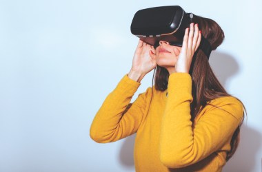 A woman wears a virtual-reality headset.