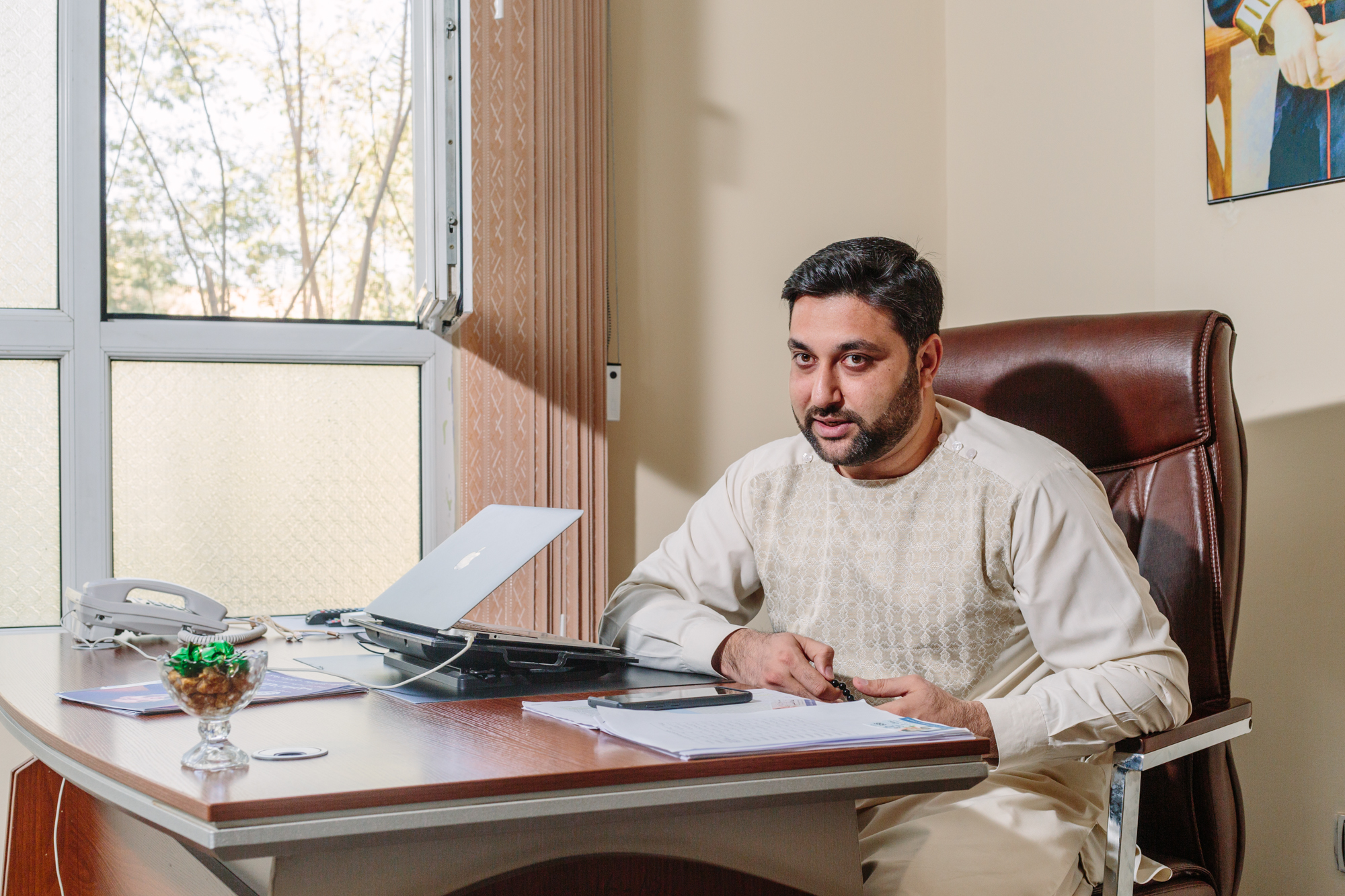 Attaullah Nasib sits at his desk in his Kabul campaign headquarters days before the parliamentary election.