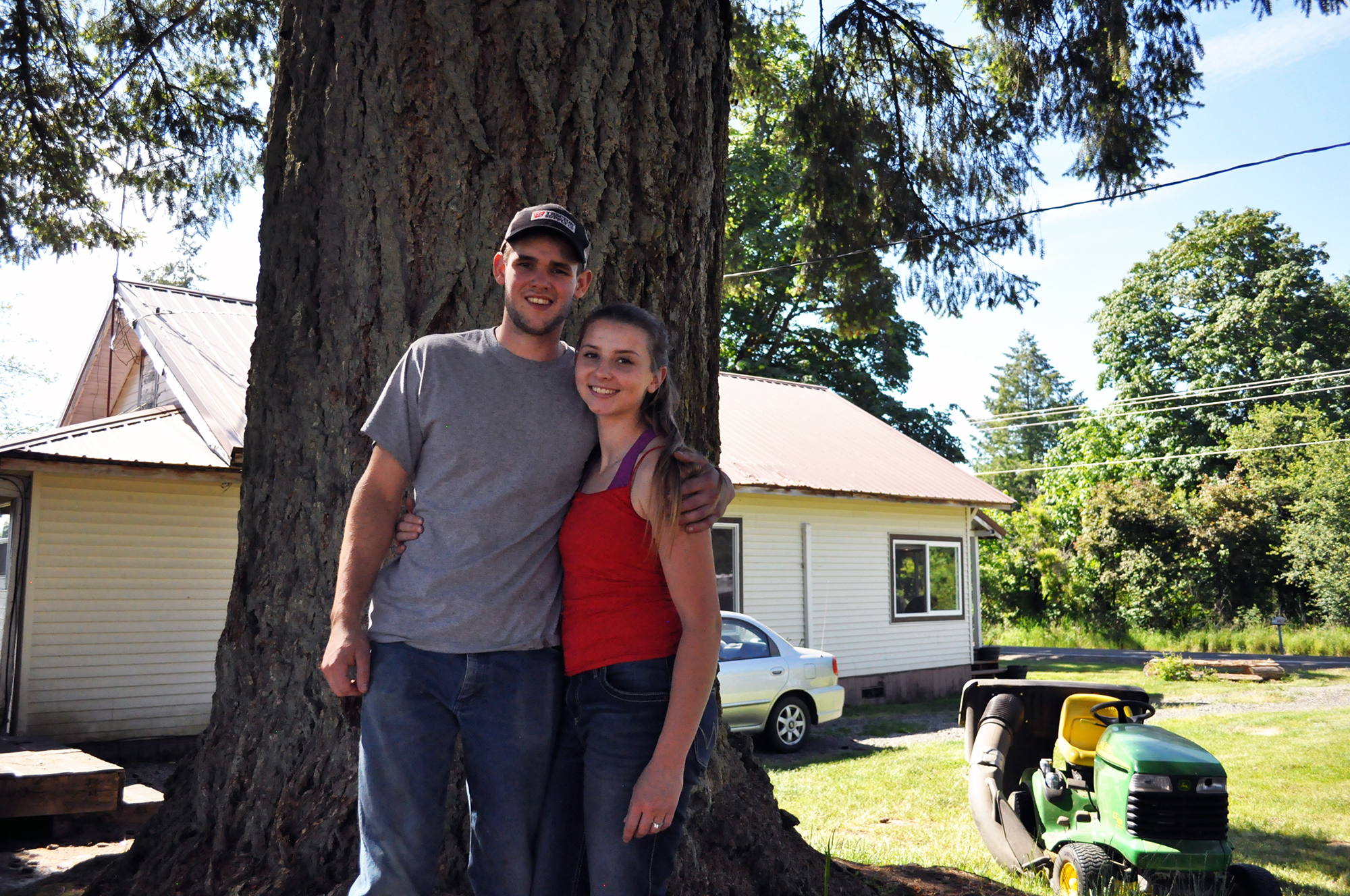 Hunter Blair and his fiancée, Ronnie Kinsman, pose in the field behind their home on June 2nd, 2018, in Onalaska, Washington. The pair graduated from Onalaska High School in 2017 and 2016 respectively, and say they intend to settle down in their hometown.