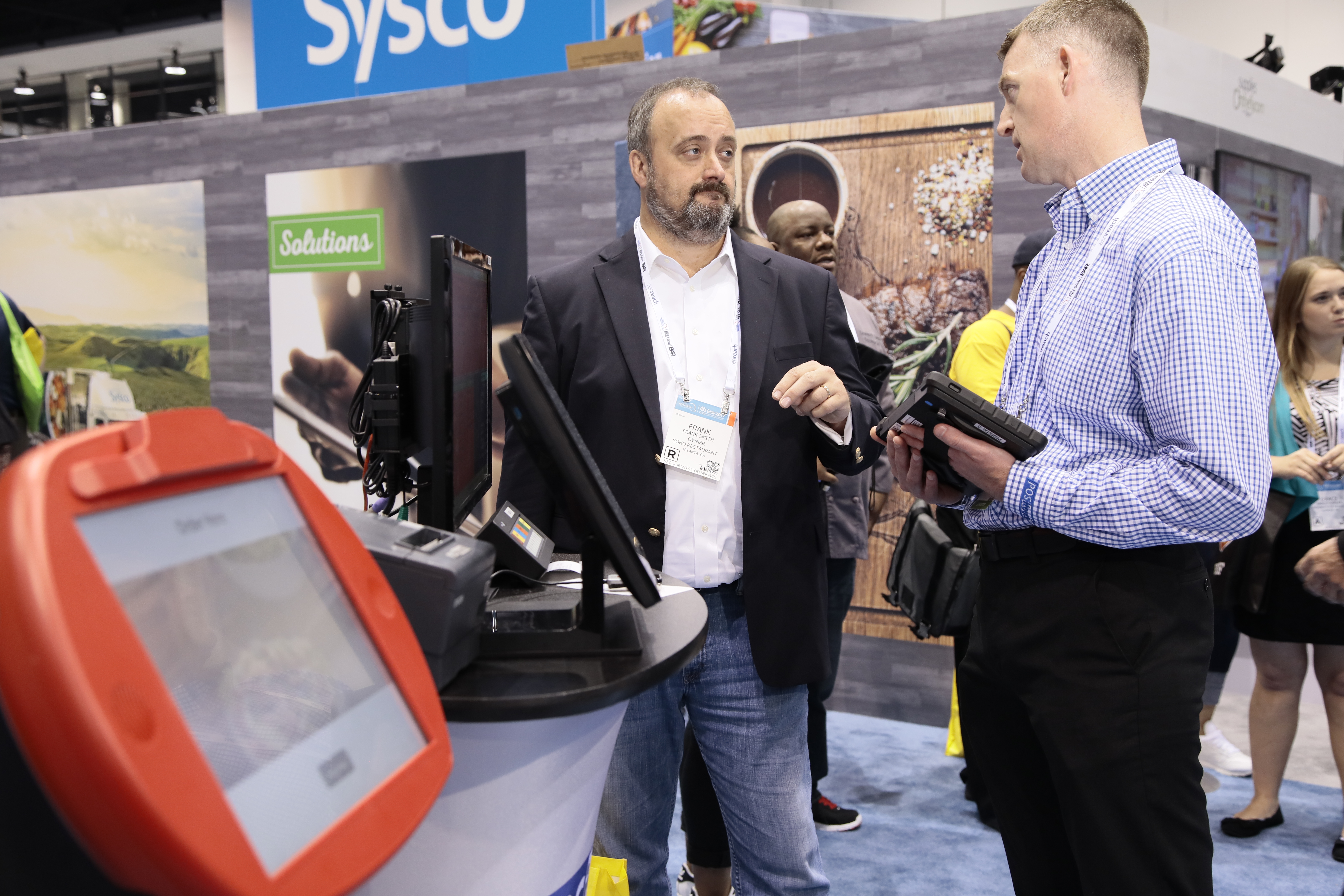 An NRA attendee chats with a corporate representative in Tech Alley.