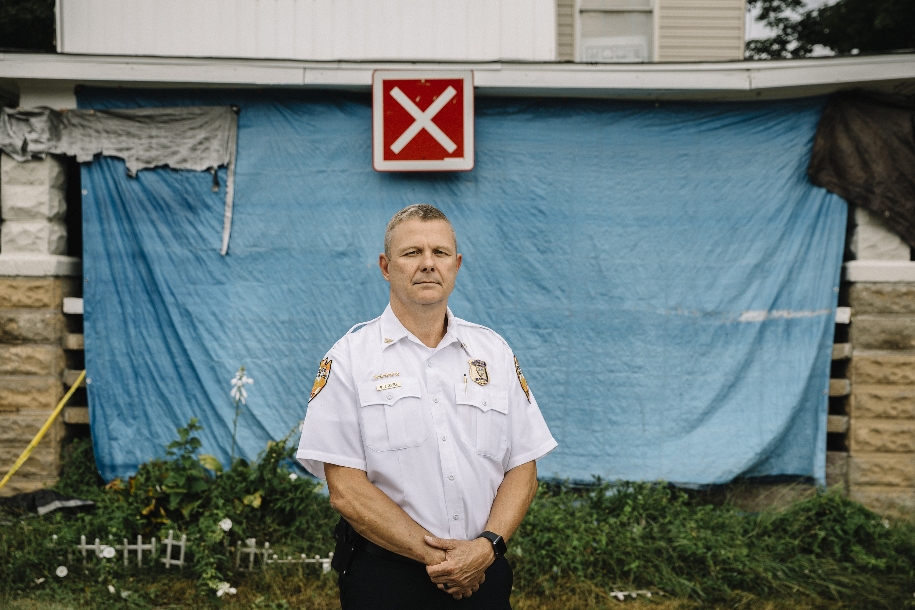 Newark, Ohio, September 7th, 2018: Newark Police Chief Barry Connell stands in front of a house on Bates Street that was closed as part of an effort to vacate unsafe housing. The red X sign denotes unsafe conditions for firefighters.