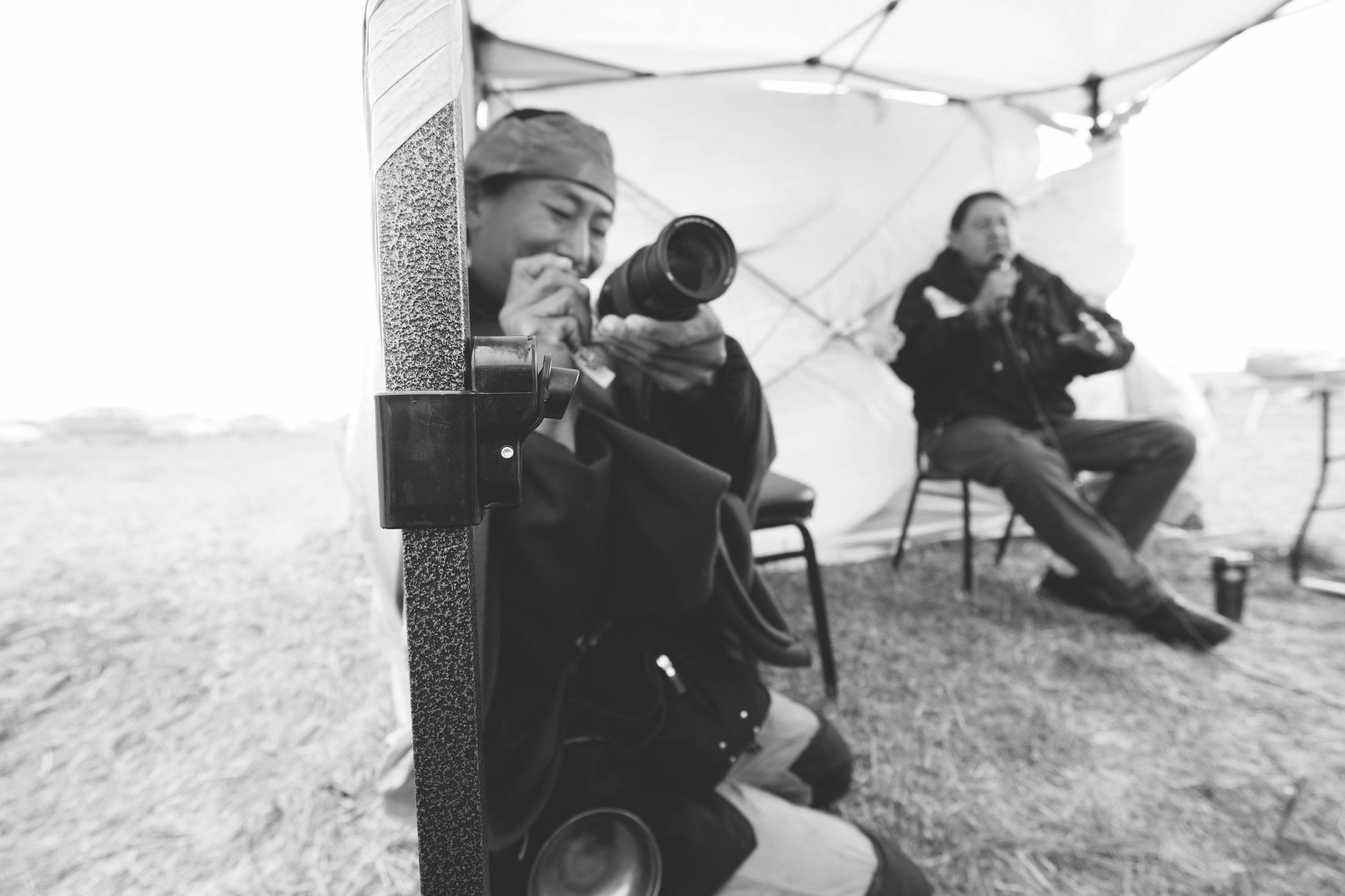 Cheyenne activist and discussion leader Raymond Kingfisher (right) speaks to an audience at the Mni Wiconi Healing Gathering.