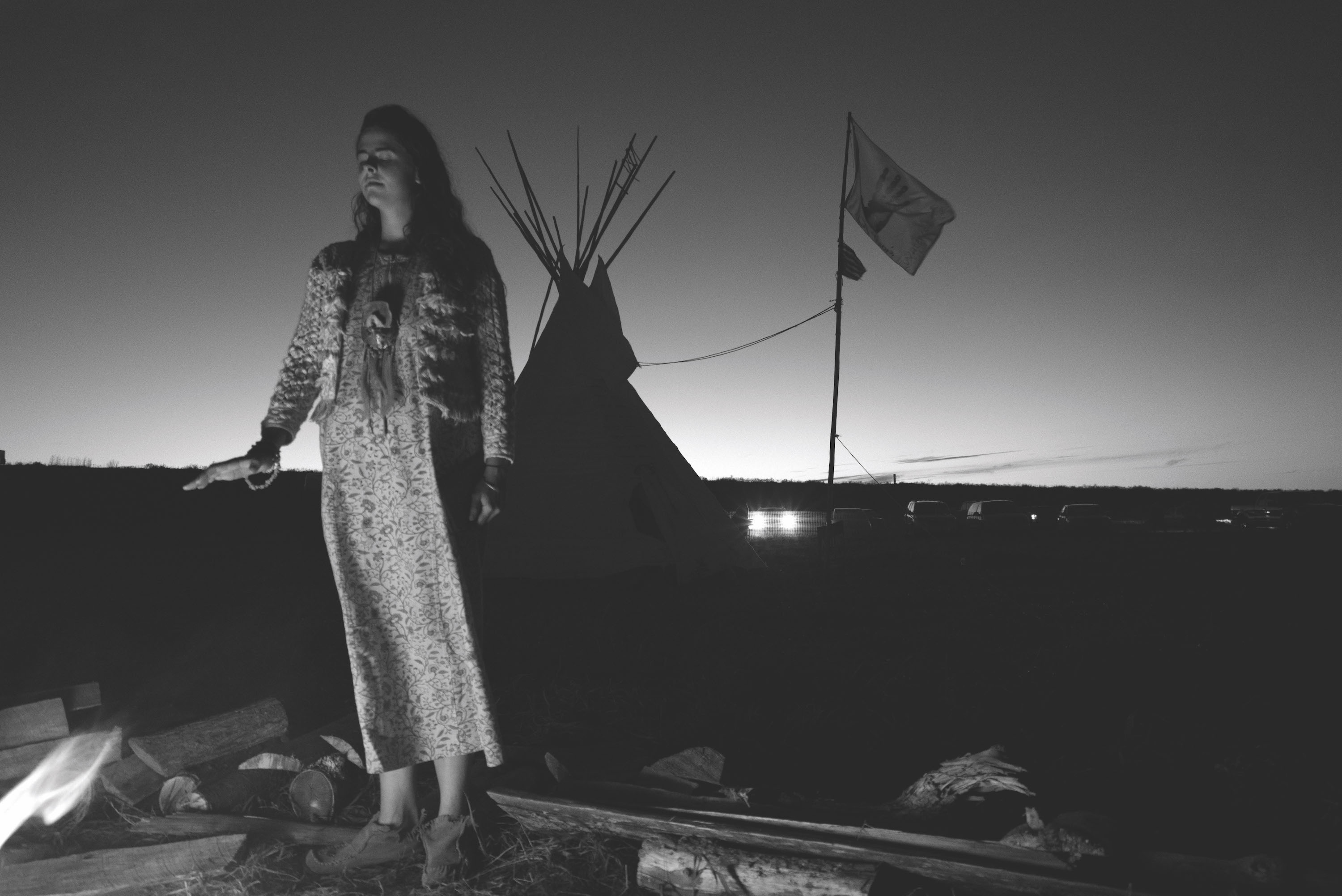 A quiet moment by the fire at Sacred Stone Village.