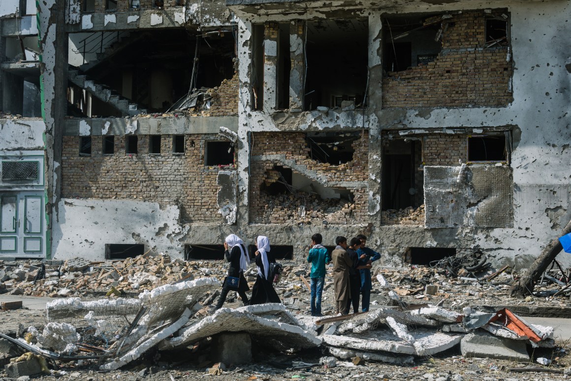 Locals gather near the site of a complex attack that killed at least 20 people and injured 50 more in Kabul, Afghanistan, on July 28th, 2019. The target of the attack was the campaign headquarters of President Ashraf Ghani's vice presidential running mate, Amrullah Saleh.