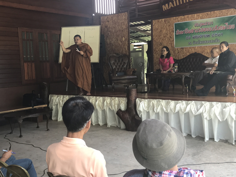 Phrakhu Sangkom Thanapanyo Khunsuri giving a speech on the importance of trees and stopping deforestation to the villagers of Surin, Thailand.