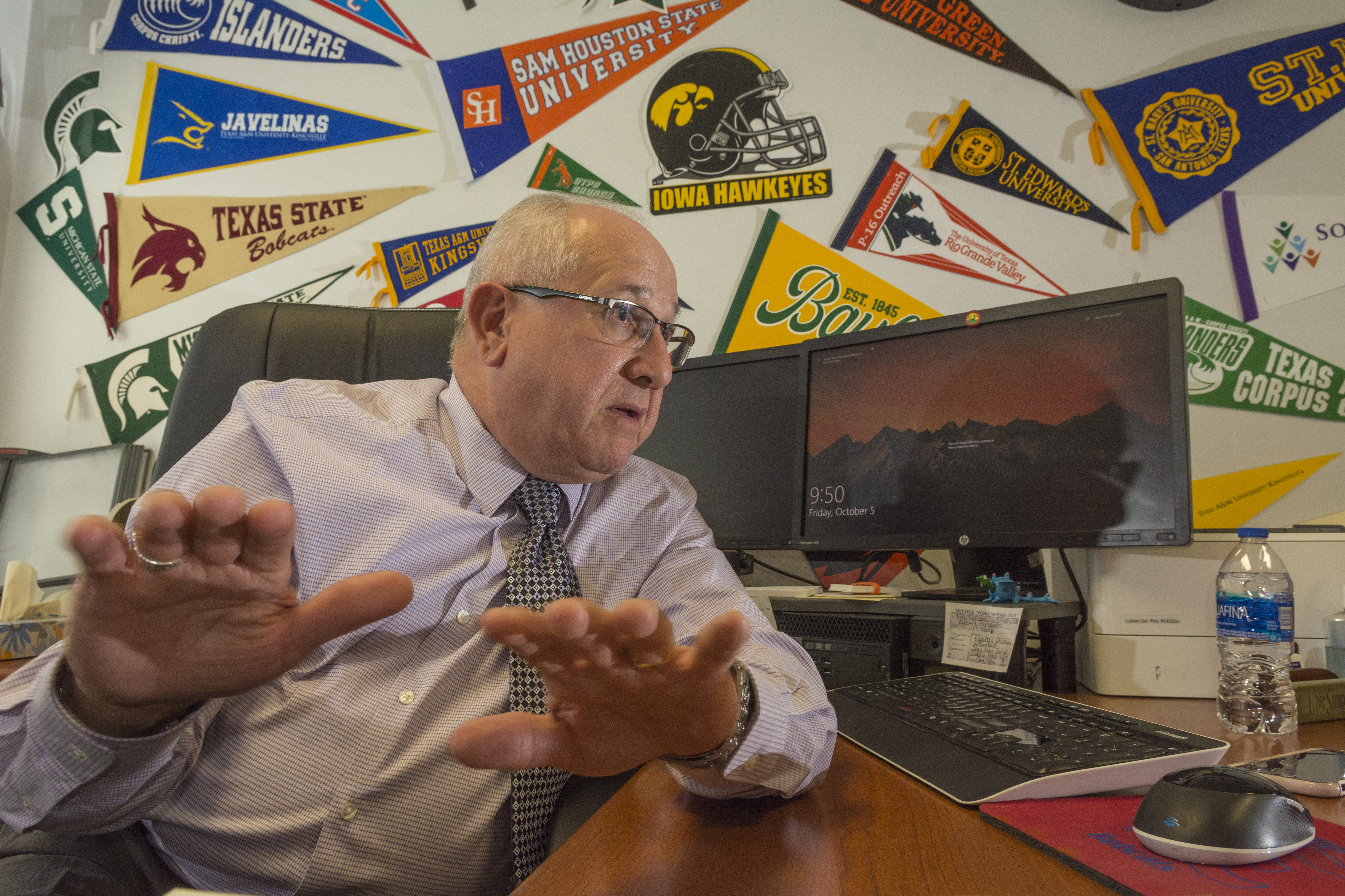 Portrait of Roberto Garcia, migrant student counselor, in his office in Edinburg High School.