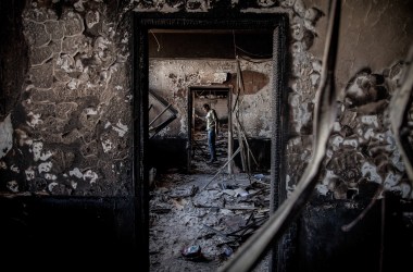 Benghazi, Libya: On the outskirts of the city, a man stands in a government building that was burned by the opposition in February of 2011, at the beginning of a revolution against the 41-year regime of Muammar Gaddafi.